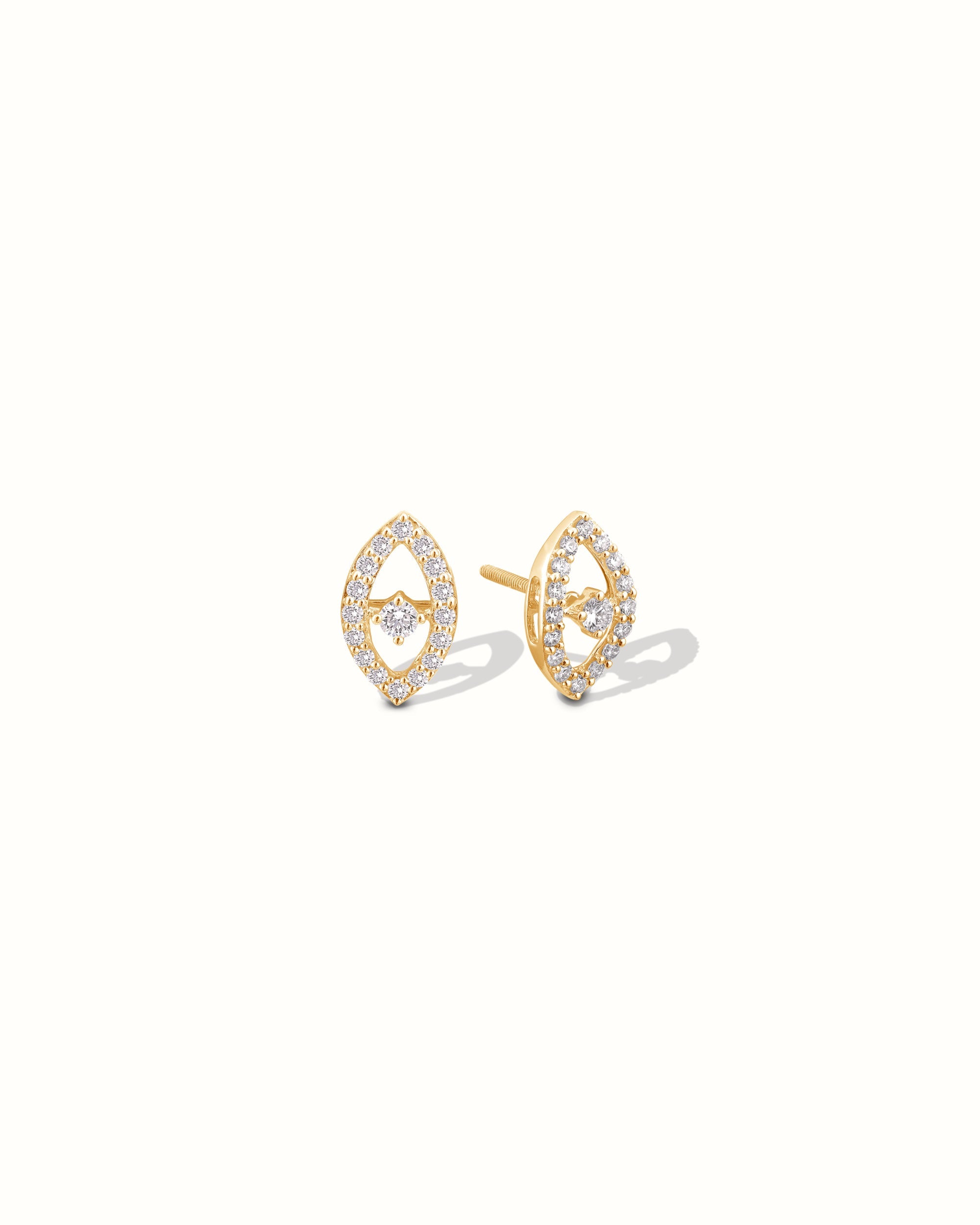 Gold earrings with diamond accents on a white background